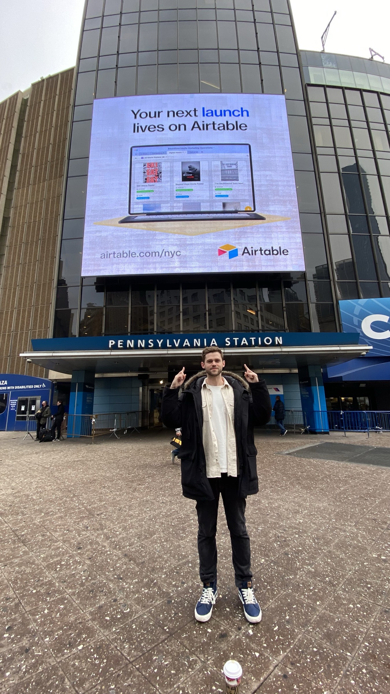 Kevin pointing at Airtable OOH billboard outside Penn Station